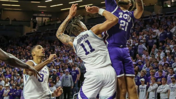 Feb 7, 2023; Manhattan, Kansas, USA; TCU Horned Frogs forward JaKobe Coles (21) shoots against Kansas State Wildcats guard Keyontae Johnson (11) during the second half at Bramlage Coliseum.